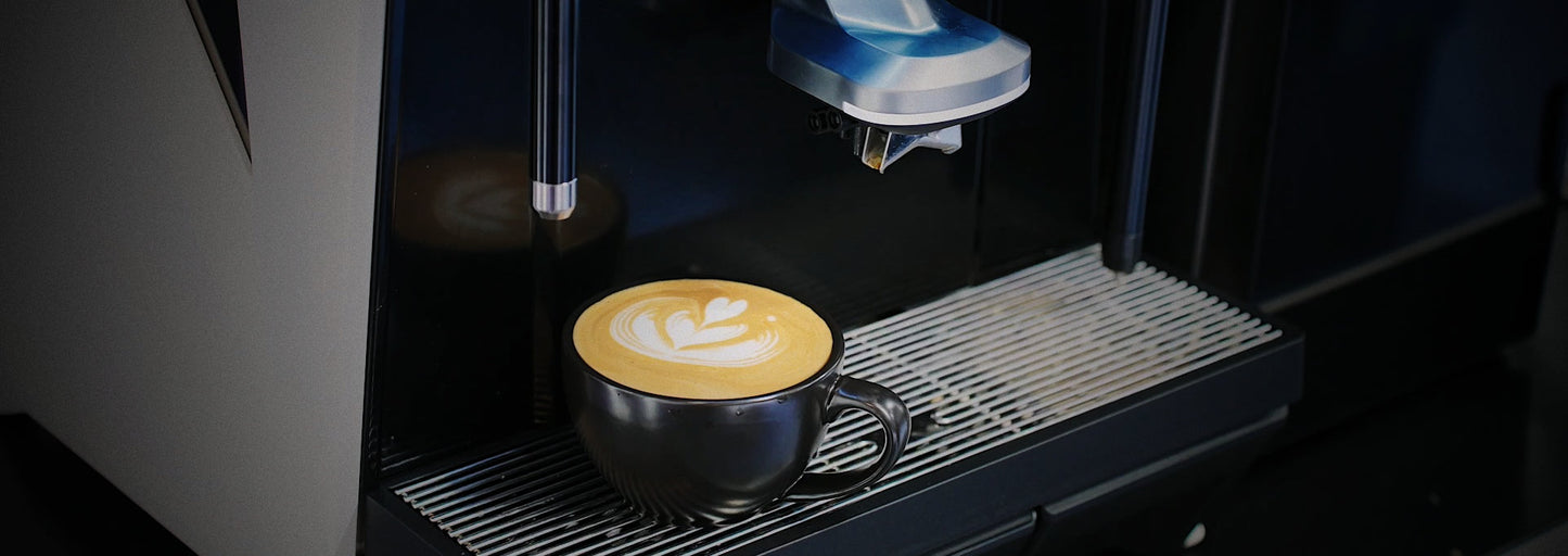CAYE-SMART-X Espresso machine dispensing a cup of coffee with latte art.