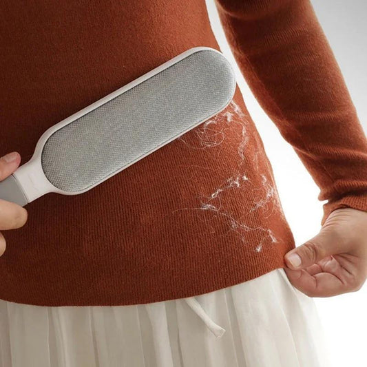 Gray white pet hair remover tool with textured surface for clothes